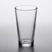 An Arcoroc mixing glass on a white surface.