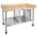 A John Boos wood top work table with a stainless steel base and undershelf on wheels.