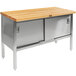 A John Boos wood top work table with stainless steel base and sliding doors.