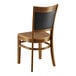 A Lancaster Table & Seating Sofia wooden chair with a black wood back.