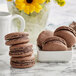 A close up of a stack of White Toque French Chocolate Macarons.