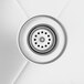 A close-up of a sink drain on a Regency stainless steel corner work table with sink.