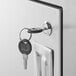 A Regency stainless steel beverage table with a sink and a key in a keyhole.