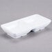 A white rectangular dish with two sections.