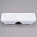 Two white rectangular Carlisle double melamine ramekins.