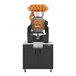 A high-capacity automatic feed juicer with a wide black podium, designed to process up to 40 fruits per minute.