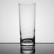 A Stolzle tall tumbler with a white liquid in it.