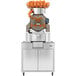 A Zumex Speed S+ commercial juicer with oranges on top.