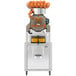 A Zumex Speed S+ juicer with oranges on top.