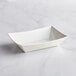 A white rectangular Tablecraft melamine serving basket.