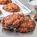 A group of Rich's apple fritter yeast donuts on a metal surface.