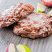 A Rich's ready-to-finish apple fritter yeast donut with glaze and apples on a table.