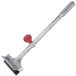 A Vollrath Red Grill Scraper with a red handle.