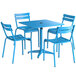 A blue Lancaster Table & Seating dining height outdoor table with four blue chairs and an umbrella in a patio.