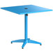 A blue square Lancaster Table & Seating outdoor table with a black umbrella hole on top.