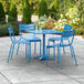 A blue table with 4 blue chairs on a patio.