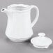 A white Tuxton Chicago teapot with a lid.