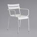 A white metal arm chair with armrests.