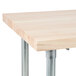 An Advance Tabco wood top work table with a galvanized metal base.