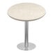 A round table with a nebula gray quartz surface on a metal base.