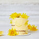 A cake with yellow flowers and lemon slices with Rich's Bettercreme Lemon Whipped Icing.