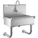 A stainless steel Regency hand sink with a hands-free sensor faucet.