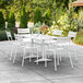 A white table and chairs on an outdoor patio.