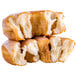 A stack of Rich's pershing yeast donuts with icing on top.