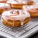 A group of Rich's pershing yeast donuts on a cooling rack.