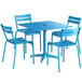 A blue Lancaster Table & Seating outdoor table with chairs and an umbrella.