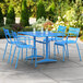 A blue table and chairs on a patio.