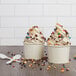 Two cups of Rich's vanilla oat milk soft serve with sprinkles and chocolate chips.