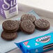 A blue napkin with a group of Nabisco Oreo cookies next to a Nabisco Oreo package.