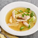 A bowl of College Inn chicken stock soup with meat and vegetables.