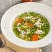 A bowl of College Inn chicken broth with vegetables and chicken.