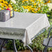 A table with a Choice clear vinyl table cover protector on it.