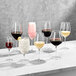 A group of Della Luce Maia wine glasses on a marble table.