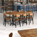 A Lancaster Table & Seating butcher block table with chairs around it in a restaurant dining area.