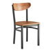 A Lancaster Table & Seating wooden chair with a wooden seat and black frame.