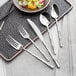 A silver tray with a fork and knife on it.