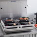 A dual-burner induction cooktop with digital controls and frying pans in use, designed for commercial kitchen settings.