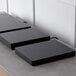 Three black rectangular Spring USA LoPRO Slim-line induction ranges on a counter.