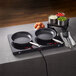 A Spring USA slim-line double induction cook and hold range with pans on it.