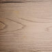 A close up of a Lancaster Table & Seating gray wood seat with a wood grain surface.