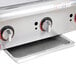 An APW Wyott stainless steel countertop gas griddle with three burners.