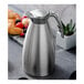 An Alfi stainless steel coffee carafe with a lid and handle.