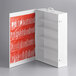 A white and orange Medique first aid cabinet with plastic shelves inside.