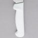 A Dexter-Russell Basics white bread and sandwich knife with a handle and wavy blade.