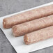 Warrington Farm Meats sweet Italian turkey sausage links on a white surface.