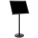 A black sign on a black stand.